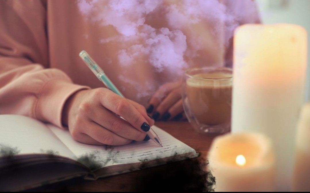 Hand writing in a journal by candlelight — guided healing e-books